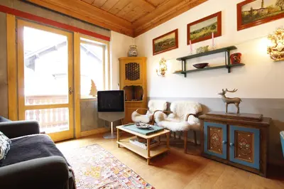 a living room with a couch and a tv at Casa in Centro di Cortina D'Ampezzo in Cortina dʼAmpezzo