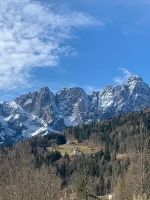 a view of a mountain range with snow at Mansarda Chiara - locazione turistica in Gosaldo