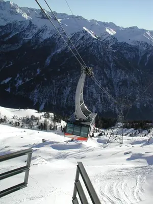 a ski lift on top of a snow covered mountain at Hotel Crepes de Sela in Campitello di Fassa