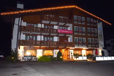 a large building with a balcony on top of it at Hotel Crepes de Sela in Campitello di Fassa
