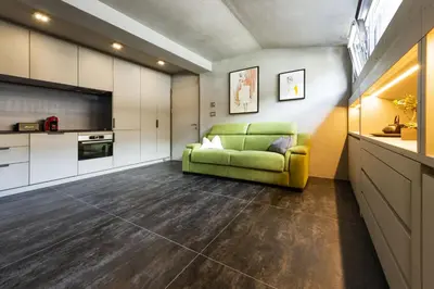 a living room with a green couch in a room at Loft at 1236 in Ortisei