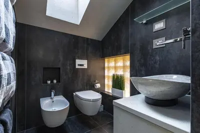 a bathroom with a sink and a toilet at Loft at 1236 in Ortisei