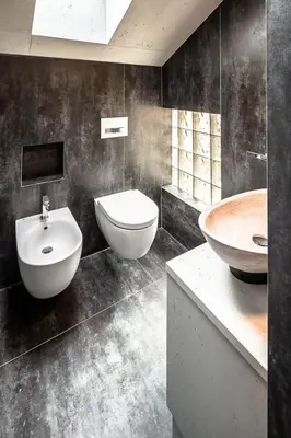 a bathroom with a sink and a toilet and a tub at Loft at 1236 in Ortisei