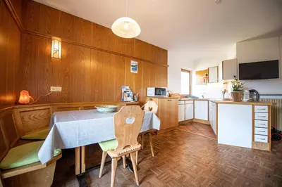 a kitchen with a table and chairs in a room at Bonichhof in Laion