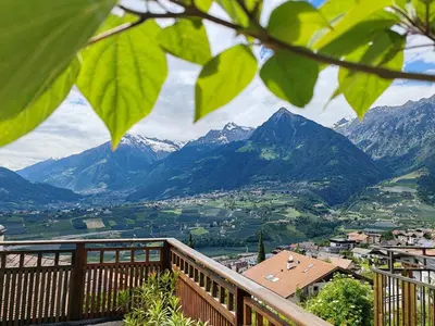 a view of a valley from a balcony with mountains at Schenna Garni Eden Bed & Breakfast in Schenna