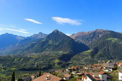 a town in a valley with mountains in the background at Schenna Garni Eden Bed & Breakfast in Schenna