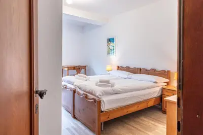 a bedroom with a large bed in a room at Casa Bigontina, in pieno centro a Cortina in Cortina dʼAmpezzo