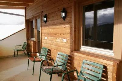 a room with four chairs and a window at Pension Ferienwohnungen Marchnerhof in Terento