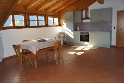 a kitchen with a table and chairs in a room at Schabelhof in Laives