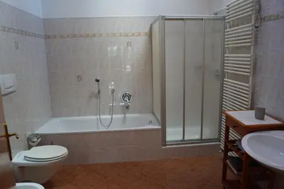 a bathroom with a tub and a toilet and a sink at Schabelhof in Laives