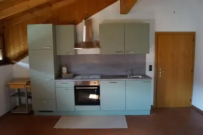 a kitchen with blue cabinets and a sink and a stove at Schabelhof in Laives