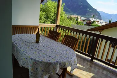 a table with a vase sitting on top of a balcony at Schabelhof in Laives