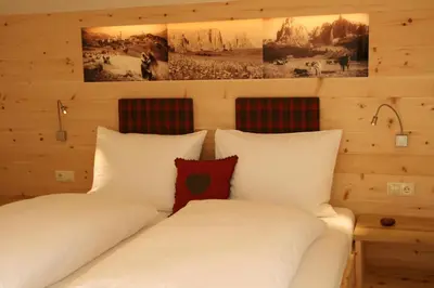 a bedroom with two white pillows on a bed at Trafunshof natural living in Vols am Schlern