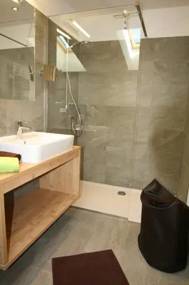 a bathroom with a sink and a shower at Trafunshof natural living in Vols am Schlern