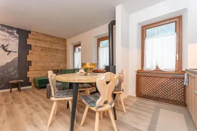 a dining room with a table and chairs at Ciesa Abete Rosso in Caprile