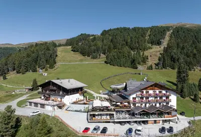 an aerial view of a hotel on a mountain at Berghotel Schlemmer Appartements in Plancios