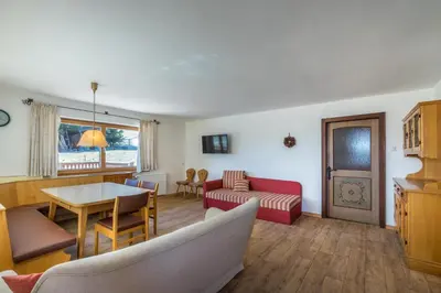 a living room with a couch and a table at Berghotel Schlemmer Appartements in Plancios