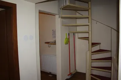 a small room with a ladder and a stair case at Berghotel Schlemmer Appartements in Plancios