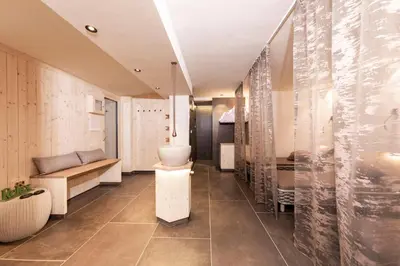 a bathroom with a toilet and a sink at Berghotel Schlemmer Appartements in Plancios