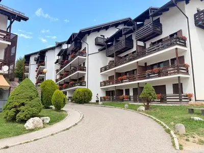 an apartment building with a winding road at Olimpo Dolomitico in Cavalese
