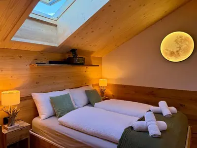 a room with two beds in a attic at Olimpo Dolomitico in Cavalese