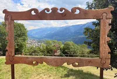 a wooden bench sitting on top of a hill at Olimpo Dolomitico in Cavalese