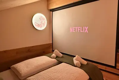 a room with a netflix sign on the wall at Olimpo Dolomitico in Cavalese