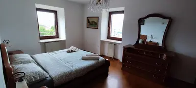 a bedroom with a bed and a dresser and a mirror at Casa Ianes in Ronzone