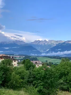 a view of a mountain range with houses and trees at Casa Ianes in Ronzone