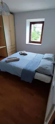 a bedroom with a large bed with a window at Casa Ianes in Ronzone