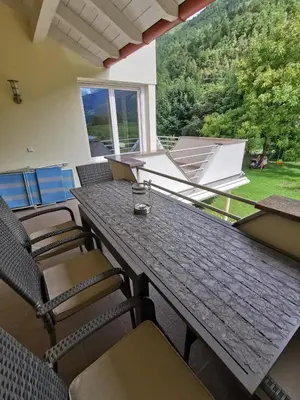 a table and chairs in a room with a large window at Apartment Dreiland in Plaus