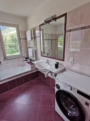a bathroom with a sink and a washing machine at Apartment Dreiland in Plaus