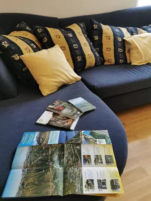 a living room with a couch and a table with magazines at Apartment Dreiland in Plaus