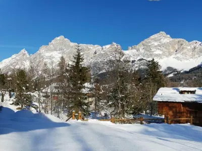 a person skiing in the snow in front of a mountain at Petit Chalet in Villanova