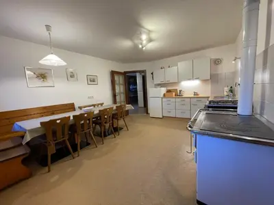 a kitchen and dining room with a table and chairs at Landhaus Schneider in Vallarga