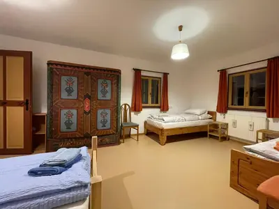 a room with two beds and a bedroom with a bed sqor at Landhaus Schneider in Vallarga