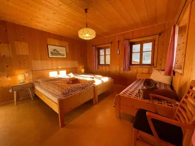 a bedroom with two beds in a wooden cabin at Landhaus Schneider in Vallarga
