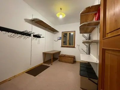 a room with a table and a shelf with weapons at Landhaus Schneider in Vallarga