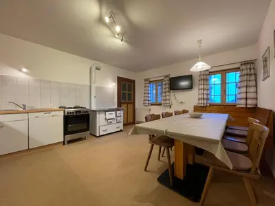 a kitchen and dining room with a table and chairs at Landhaus Schneider in Vallarga