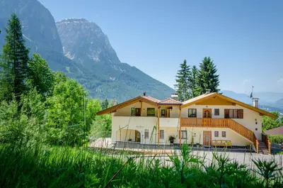 a house with a mountain in the background at AppartmentPircher 2 in Siusi