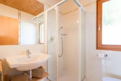 a bathroom with a sink and a shower at AppartmentPircher 2 in Siusi