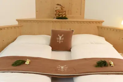 two beds in a room with christmas decorations on them at Apartments Villa Montana in Ortisei
