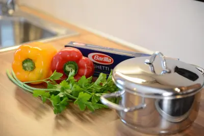 a pile of vegetables on a counter next to a juicer at Apartments Villa Montana in Ortisei