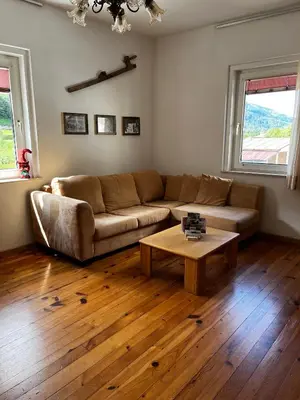 a living room with a couch and a coffee table at Appartamento Le Sipole in Ziano di Fiemme