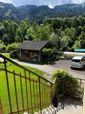 a house with a car parked in front of it at Appartamento Le Sipole in Ziano di Fiemme