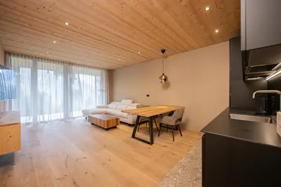 a living room with a white couch and a table at Munt Dolomiti Farm in Plancios
