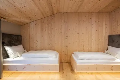 a bed in a room with a large window at Munt Dolomiti Farm in Plancios