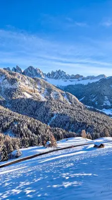 a snow covered mountain with mountains in the background at Munt Dolomiti Farm in Plancios