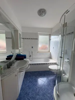a bathroom with two sinks and a tub and a toilet at Apartment Apfel in Naturno