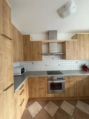 a kitchen with wooden cabinets and a stove top oven at Apartment Apfel in Naturno